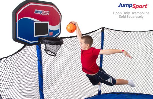 The boy jumping and throwing basketball at the hoop basket