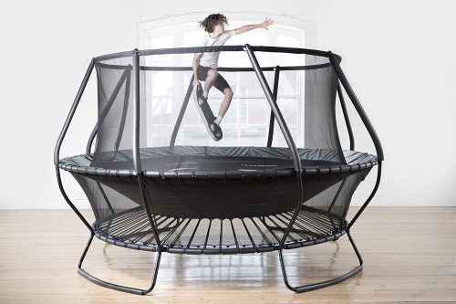 A boy playing bounce board on trampoline