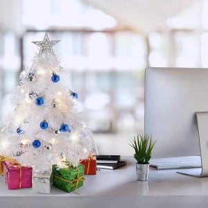 White mini-Christmas tree sitting on the computer desk